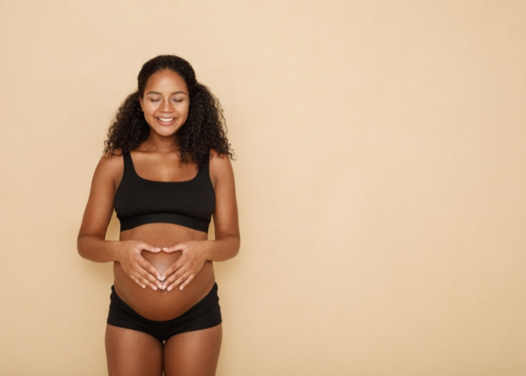 woman pregnant hands over belly