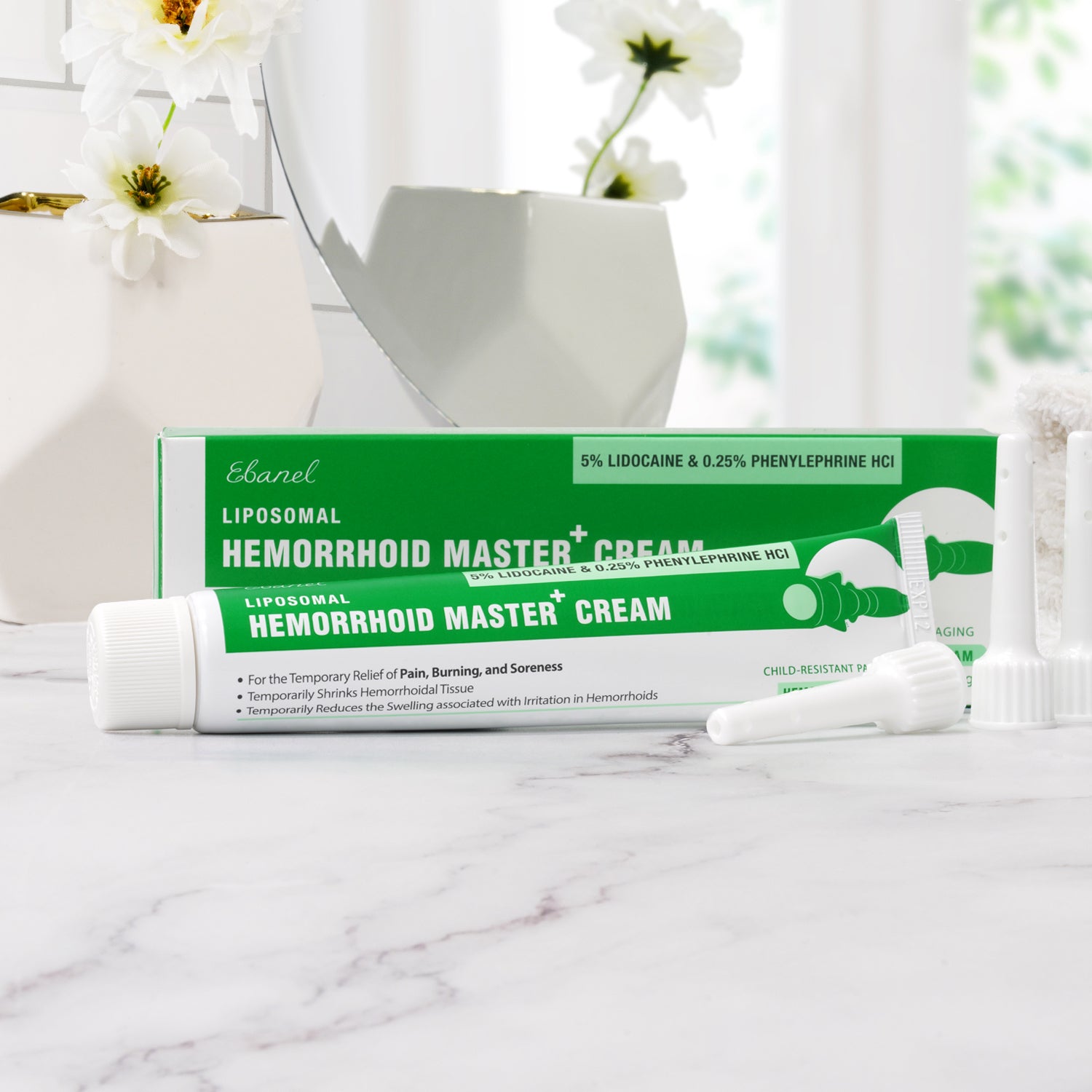 The product tube is white with blue and green accents, featuring the Ebanel logo. The packaging highlights key ingredients like Witch Hazel, Centella Asiatica, Horse Chestnut, and Frankincense. The cream is designed to provide relief from hemorrhoid symptoms such as pain, itching, and swelling.